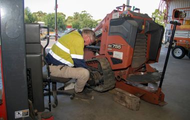 Mechanic fitting genuine replacement parts on heavy equipment at Busselton Equipment Hire – reliable trailer repairs Busselton using quality components.