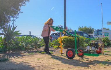 Photo of Owner of Busselton Equipment Hire demonstrating the easy use of the newest Post Hole Digger.